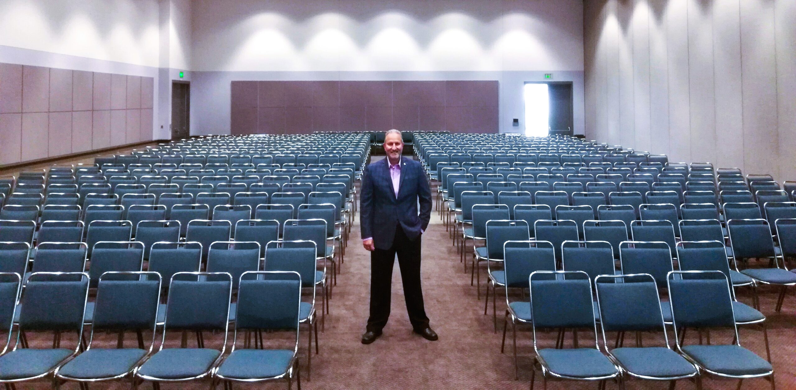 Russ posing in front of room.
